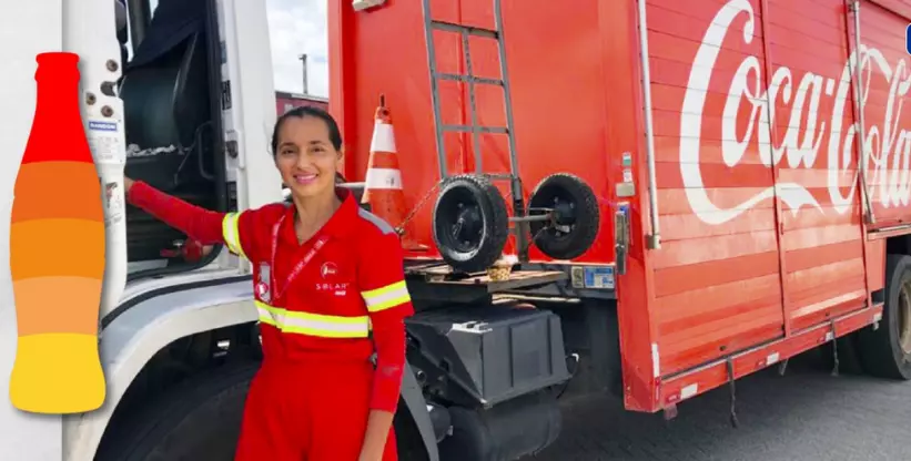 A foto mostra a funcionária da Solar Coca-Cola ao lado da porta aberta do caminhão